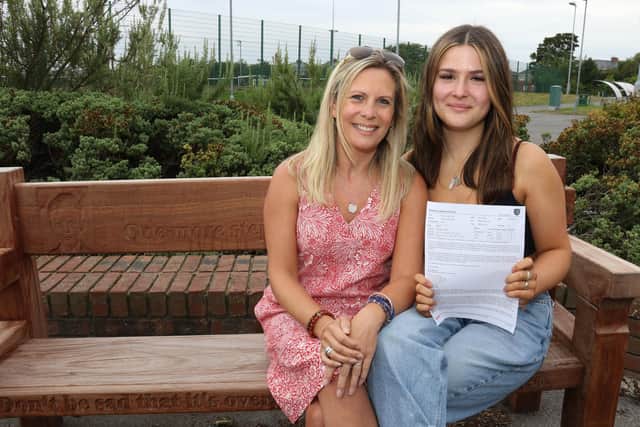 Josie Todd and her mum Clair on the memorial bench at Bede Academy, in Blyth, which honours Connor.