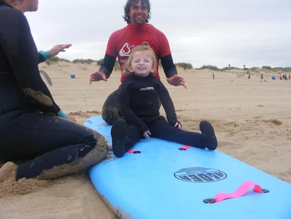 Sophia, from Blyth, enjoying a surfing lesson thanks to St Oswald’s Children’s Service.