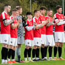 Ashington players take part in a minute's applause for Sir Bobby in their changed red strip. Picture: Ian Brodie