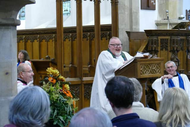 Rev Canon John Sinclair shares a joke at his final service.