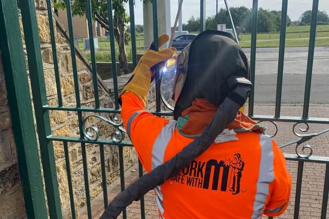 Welders from Miller UK helped repair the gate at the shelter. (Photo by Miller UK)