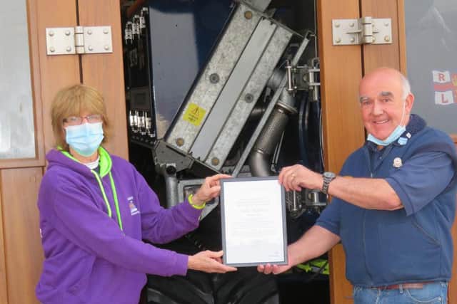 Seahouses lifeboat crew member Julie Harris is presented with her volunteer award certificate by operations manager Ian Clayton.