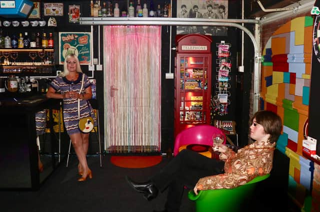 Pam Johnstone enjoys a drink in her Cavern Club inspired home bar.
