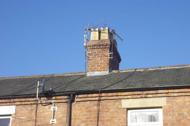 Square white chimney pots with battlements, early 1900s.