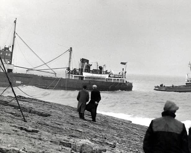 A tug boat tries to pull the cargo ship, Yewglen, from rocks at Beadnell Point on February 29, 1960. Picture: Brian Wood