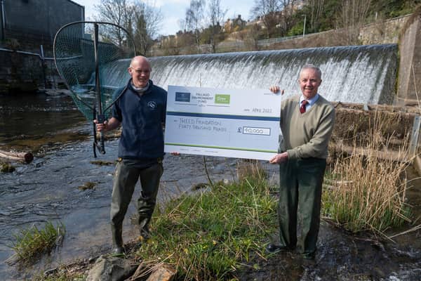 Fallago Environment Fund Chairman, Gareth Baird presents a cheque for £40,000 to Tweed Foundation biologist, James Hunt to help fund a smolt-tracking survey that aims to improve Atlantic Salmon stocks on the River Tweed.