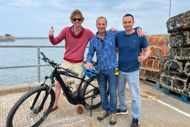Robson Green with Martin Newton and Tristan Jeffrey of Go Electric in Seahouses.