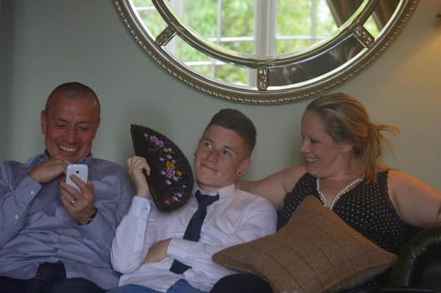 Kyle Dilks with his dad Neil and mum Kelly.