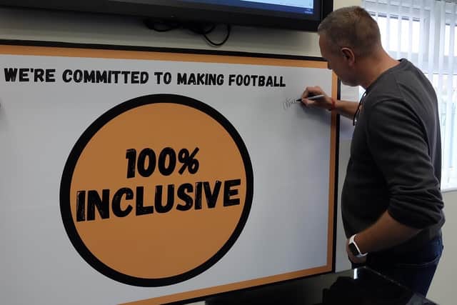 Steve Howey signs the pledge board for the campaign.