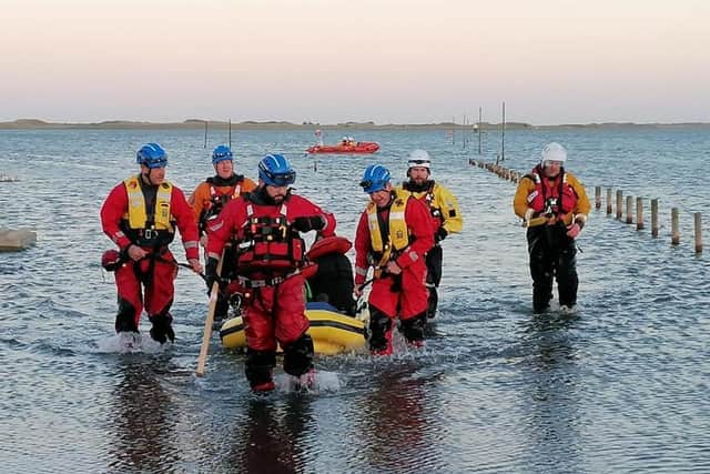 Five people, including four children, had to be rescued from Holy Island causeway after being caught in the rising tide. Picture: Berwick Coastguard Rescue Team.