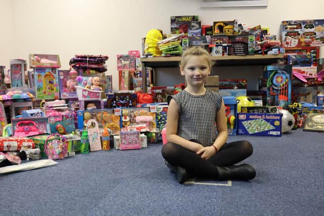 Scarlett Duke with some of the donated toys and gifts.