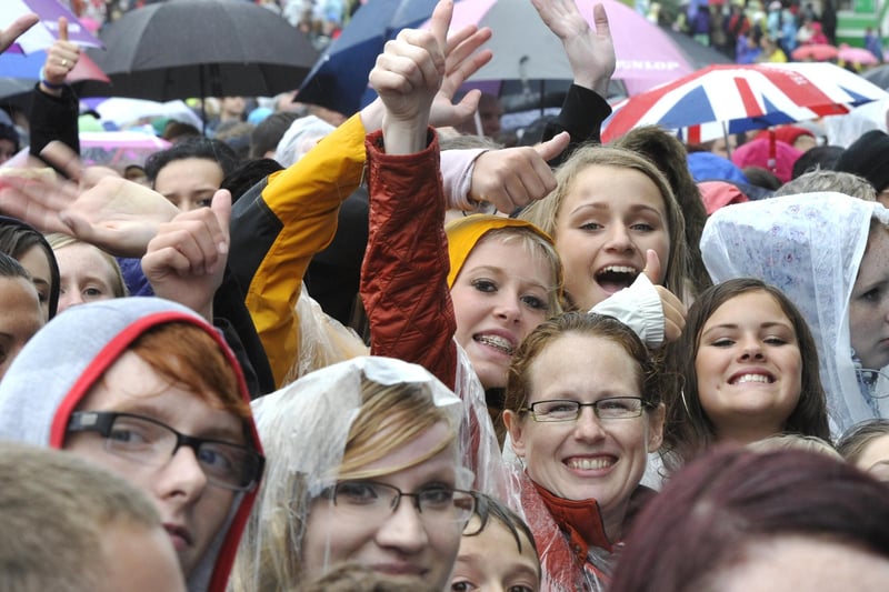 Crowds wave at the camera before Jessie J takes to the stage for her 2012 concert at Alnwick Castle.