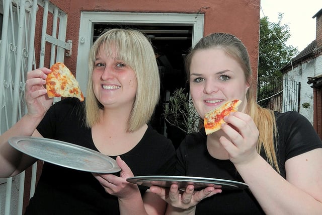 Olive Grove staff members  Meggan Gambles (left) and Ashlie Mellott show off some of the free pizza slices on offer during buffet nights back in 2014