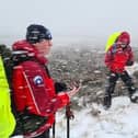 Mountain rescue teams in blizzard-like conditions