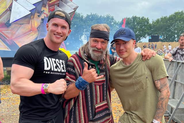 Zac Aynsley, left, and Wim Hof, centre, with a reveller at the Defqon.1 Festival.