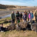 Volunteers on Holy Island display lobster crates and tyres they have collected whilst litter picking.