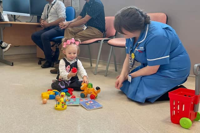 Teddi playing with toys during her assessment at the Manchester Centre for Genomic Medicine at Saint Mary’s Hospital with Rebekah Hutton, Metabolic Specialist Nurse.