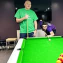 Marc Murray, 37, (purple t-shirt) and Colin Pilcher, 40, (green t-shirt) are attempting to set a new world record on the pool table.
