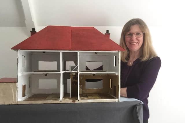 Wendy Lyons with the old doll house.