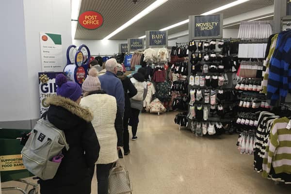 A post office queue at Asda. Picture by Alan Hughes.
