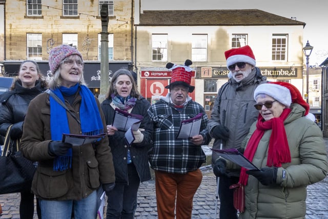 Many of the carol singers were dressed in festive hats and jumpers.