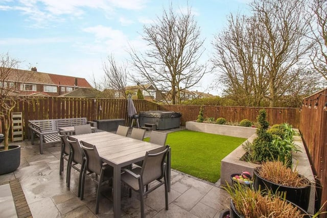 To the rear finds a sizeable garden with a delightful patio area, artificial lawn area and risen stone planters.