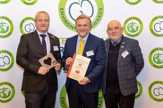 Ross Wigham, deputy director of communications, left, and Wayne Daley, head of CSR, centre, collecting the awards.