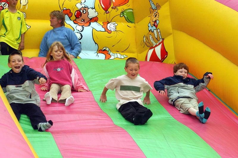 Youngsters having a fantastic time on the slide at the funfair during the 2003 Alnwick Fair.