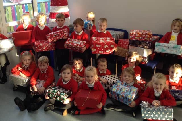 Pupils at Cragside C of E Primary with their shoeboxes for Operation Christmas Child.