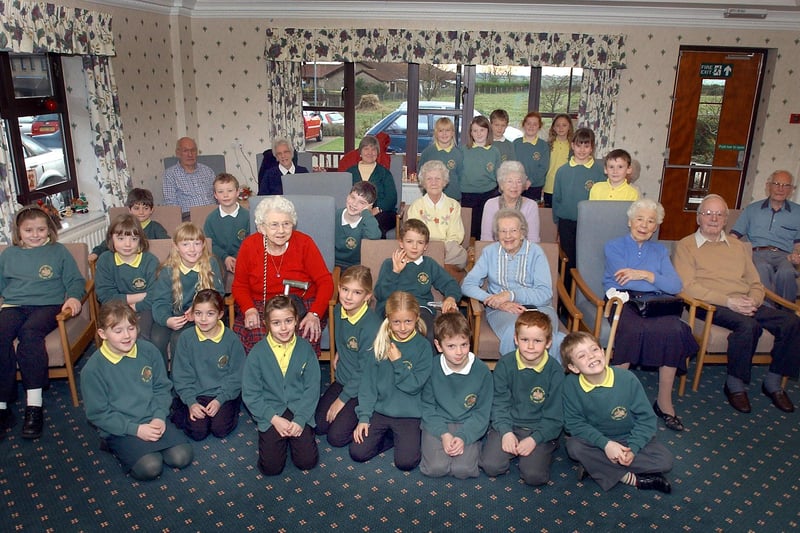 Pupils from Warkworth First School sang Christmas Carols to the residents of Newbarns Residential Home in Warkworth in December 2003.
