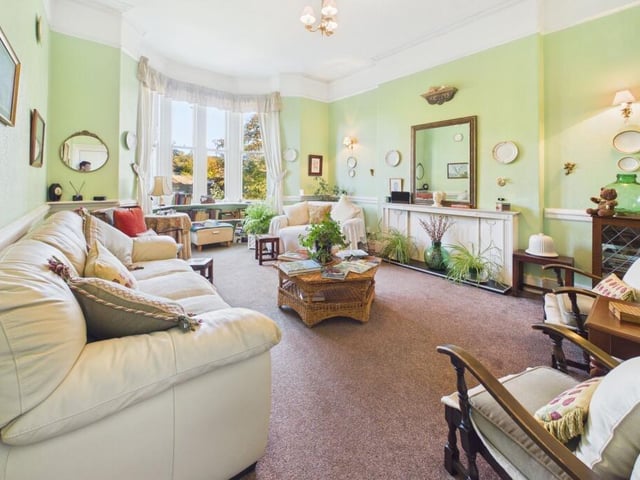 An inviting sitting room with a large bay window.