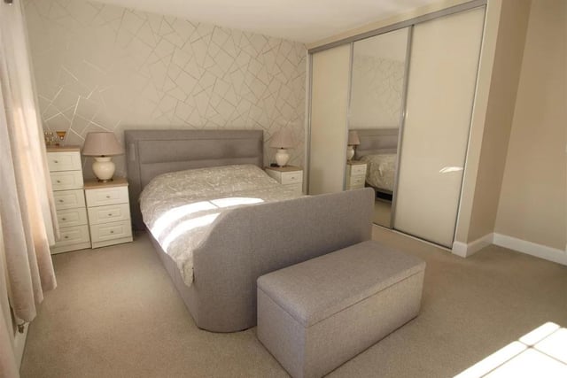 The principal bedroom features fully fitted wardrobes and adjoining en-suite facilities.