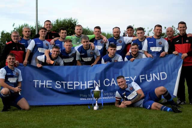 Newbiggin celebrate their third successive win in the Stephen Carey Trophy at Seahouses.