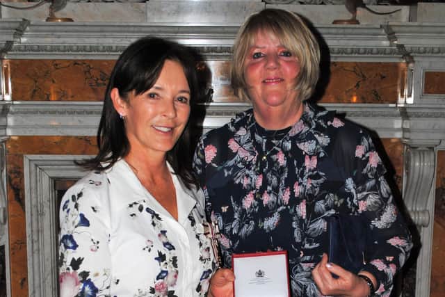 Lynne Grieves receives her British Empire Medal from Her Grace, the Duchess of Northumberland.