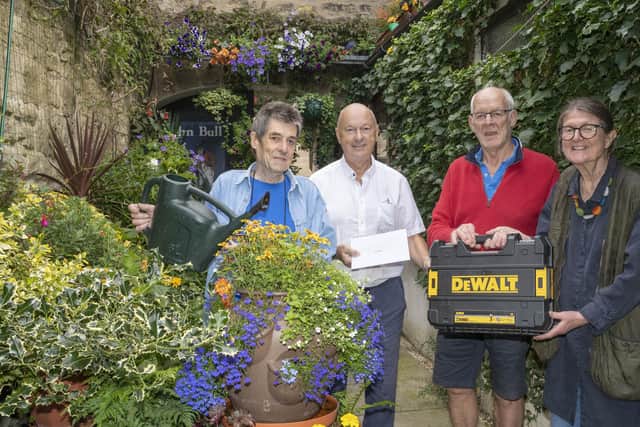 The John Bull landlord Gus Odlin in his courtyard with Carlo Biagioni and David Taylor from Alnwick Garden Town Trust and Elizabeth Jones from Alnwick in Bloom. Picture: Jane Coltman