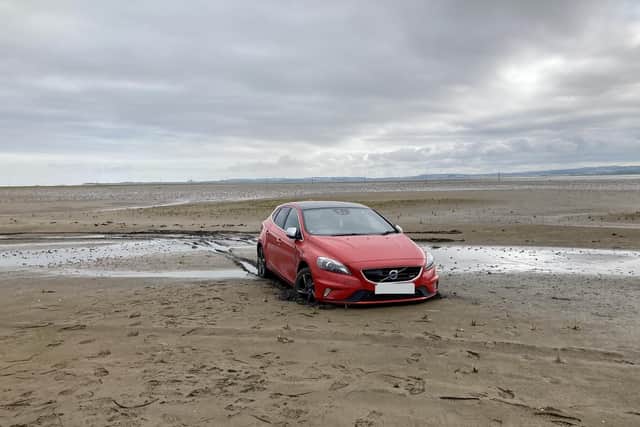 A vehicle that became stuck on the Holy Island causeway after driving onto soft sand. Photo: Colin Hardy.