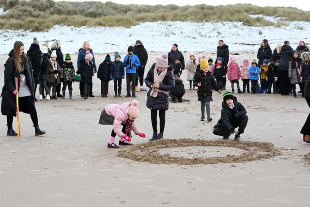 Pupils from the schools celebrating the inspections' results on Cresswell Beach.