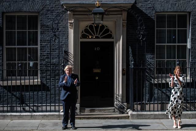 Prime Minister Boris Johnson, claps outside 10 Downing Street with founder of the Clap For Our Carers organisation, Annemarie Plas, to mark the 72nd anniversary of the NHS. Picture: Getty.