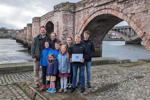 Noah Richards and his family with the Berwick Old Bridge in the background. Picture by Lindsay Benton.