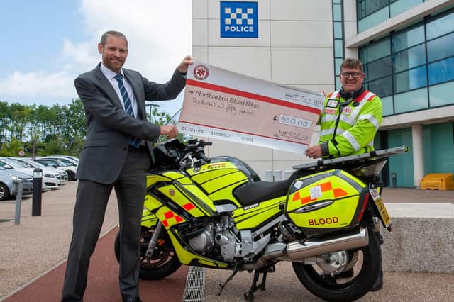 Alastair Simpson, on behalf of NERSOU, presents the cheque to John Watts.