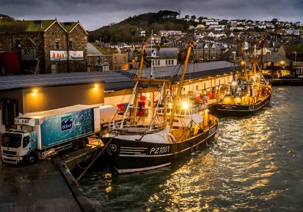 Laurence Hartwell's 'Beam trawlers landing to the fish market at night'.
