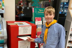 Joshua Bonham, Pegswood Sea Scouts (Portland Troup), posts a card in the box at the Pegswood Co-op.