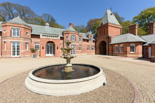 The formal drive arrives at the front of the house where there is a large gravelled courtyard with a central fountain.