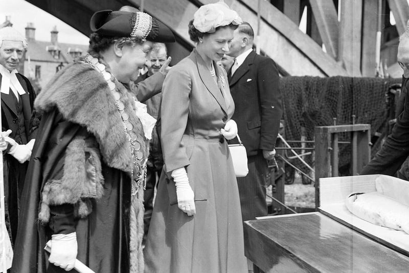 The Queen is presented with a salmon on her visit to Berwick in 1956. She is pictured with Mayor Mrs Adams by the Royal Tweed Bridge.