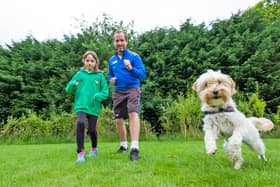 St Robert's RC First School student Sienna Bowen with head teacher David Sutcliffe, ready to complete her daily mile for charity along with school dog Honey.
