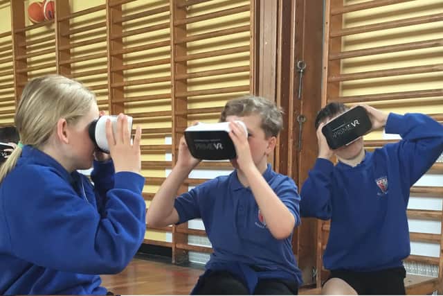 Glendale Middle School pupils try out the virtual reality headsets.