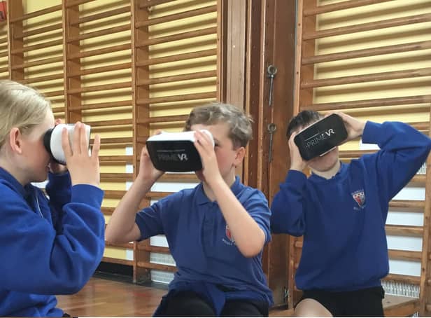 Glendale Middle School pupils try out the virtual reality headsets.