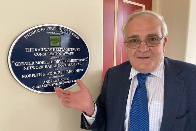 National Railway Heritage Awards panel chairman Theo Steel unveils the Conservation Category winner plaque at Morpeth Railway Station.
