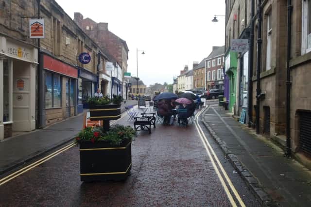 Umbrellas at the ready in Narrowgate, Alnwick, where street cafe seating was set up. Northumberland County Council says it has put funding in to help town centres operate safely during the pandemic.