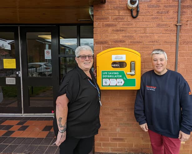 Council officer Susan Wearmouth (left) and Hartley Court staff member Jacqui Fuller with the new defibrillator. (Photo by Northumberland County Council)